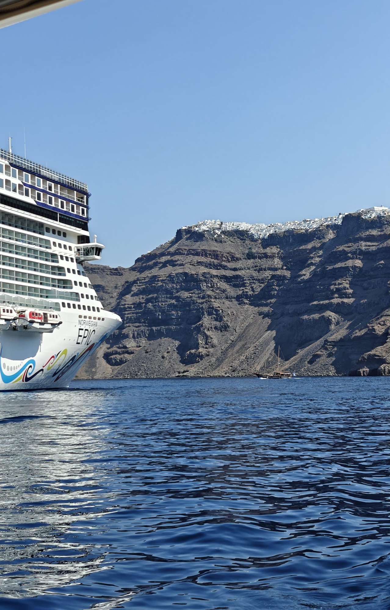 Norwegian Epic cruise ship off the cliffs of Santorini, Greece