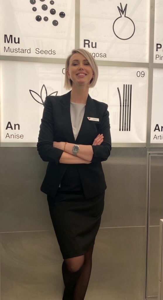 Olena Riasnianska, cruise travel advisor, working aboard a Virgin Voyages ship